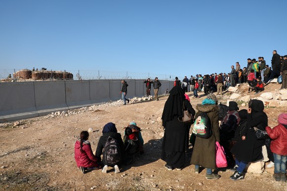 epaselect epa08188231 Syrian people gather near the Syrian-Turkish borders during a protest northwestern of Idlib, Syria, 02 February 2020. According to local reports, some 500 people joined the prote ...