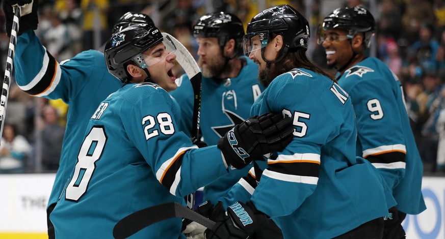 San Jose Sharks&#039; Timo Meier (28) celebrates with Erik Karlsson (65) and Evander Kane (9) after scoring against the Vancouver Canucks during the first period of an NHL hockey game Saturday, Feb. 1 ...
