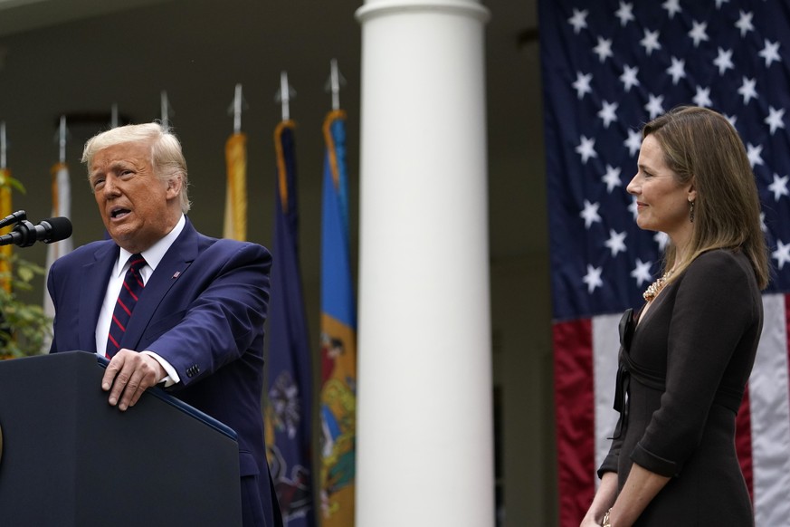 Judge Amy Coney Barrett listens as President Donald Trump announces Barrett as his nominee to the Supreme Court, in the Rose Garden at the White House, Saturday, Sept. 26, 2020, in Washington. (AP Pho ...