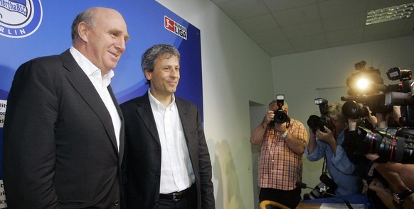 Dieter Hoeness, Manager of Hertha BSC Berlin, left, and Lucien Favre from Switzerland, the new headcoach of the German first division soccer club, smile prior to a press conference in Berlin, Saturday ...