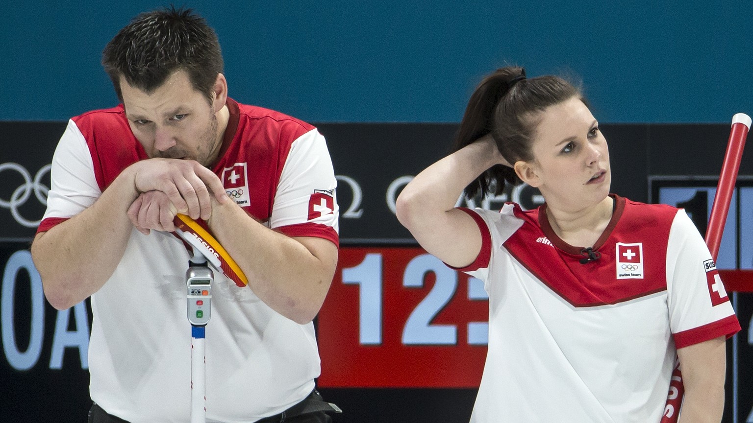 Martin Rios of Switzerland, Jenny Perret of Switzerland, and Aleksandr Krushelnitckii of the Olympic Athlete from Russia, from left, during the Mixed Doubles Curling semi final game between Switzerlan ...