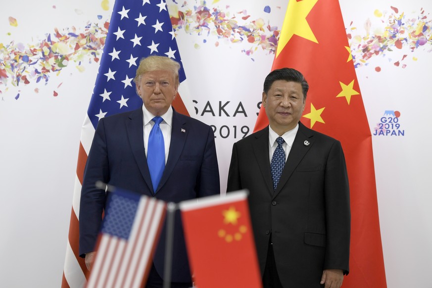 President Donald Trump, left, poses for a photo with Chinese President Xi Jinping during a meeting on the sidelines of the G-20 summit in Osaka, Japan, Saturday, June 29, 2019. (AP Photo/Susan Walsh)
 ...