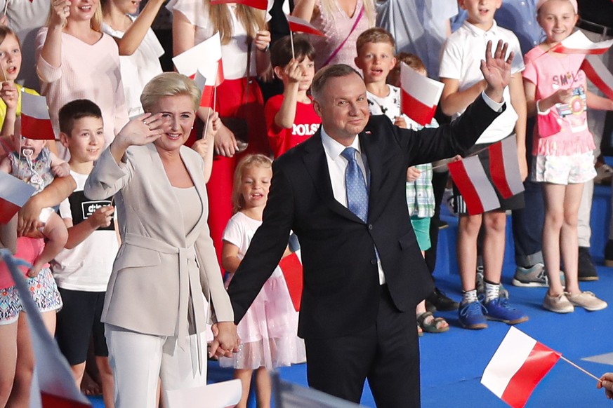 President Andrzej Duda and his wife Agata Kornhauser-Duda wave to supporters shortly after voting ended in the presidential election in Lowicz, Poland, Sunday, June 28, 2020. The election will test th ...