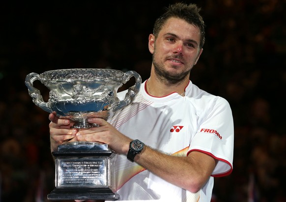 Stanislas Wawrinka of Switzerland holds the trophy after defeating Rafael Nadal of Spain during the men&#039;s singles final at the Australian Open tennis championship in Melbourne, Australia, Sunday, ...