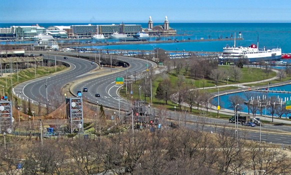 epa08339765 An aerial photo made with a drone shows a mostly deserted Lake Shore Drive near Navy Pier in Chicago, Illinois, USA, 02 April 2020. Illinois remains under a stay at home order issued by Il ...