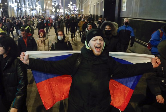 People attend a protest after Russian opposition leader Alexei Navalny was sentenced to jail in Moscow, Russia, Tuesday, Feb. 2, 2021. A Moscow court has ordered Russian opposition leader Alexei Naval ...