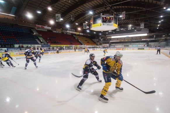 Ambri&#039;s player Fabio Hofer left fight for the puck with Davos&#039;s player Davyd Baradun righ, during the preliminary round game of National League A (NLA) Swiss Championship 2019/20 between HC  ...