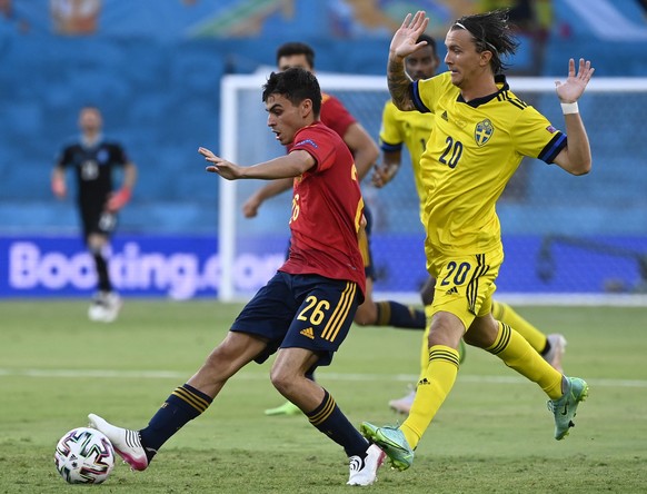 epa09271609 Pedri of Spain in action against Kristoffer Olsson of Sweden during the UEFA EURO 2020 group E preliminary round soccer match between Spain and Sweden in Seville, Spain, 14 June 2021. EPA/ ...