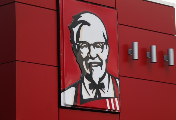 FILE - In this Tuesday, Oct. 9, 2012, file photo, a close-up of a sign with a picture of Colonel Sanders is shown on the wall of a combination Kentucky Fried Chicken, Taco Bell in Doral, Fla. Kentucky ...