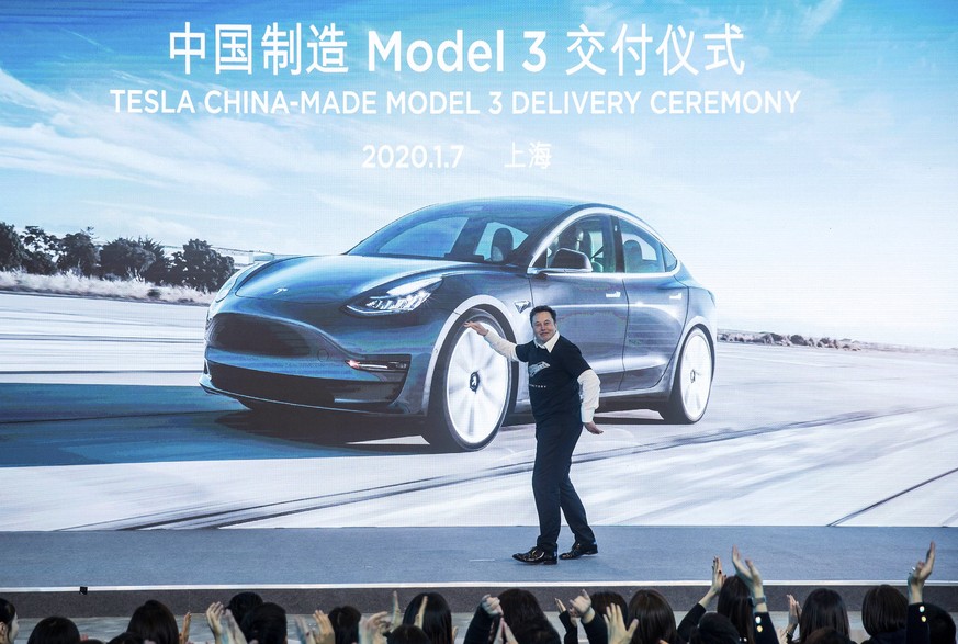 In this photo released by China&#039;s Xinhua News Agency, Tesla CEO Elon Musk reacts at a delivery ceremony for the first Tesla Model 3 cars made at Tesla&#039;s Shanghai factory in Shanghai, Tuesday ...