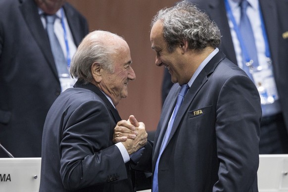 epa04863921 (FILE) FIFA President Joseph S. Blatter (L) reacts after his election as President greeted by UEFA President Michel Platini at the Hallenstadion in Zurich, Switzerland, 29 May 2015. Platin ...