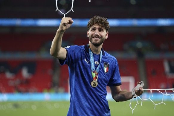 Italy&#039;s Manuel Locatelli celebrates while holding a piece of the goal net after Italy won the Euro 2020 soccer championship final match between England and Italy at Wembley stadium in London, Sun ...