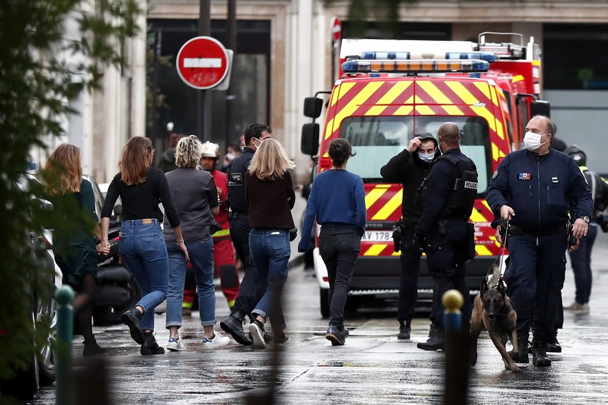 epa08696152 People are evacuated near Rue Nicolas Appert close to the former Charlie Hebdo offices, in Rue Nicolas Appert in Paris, France, 25 September 2020, after four people have been wounded in kn ...