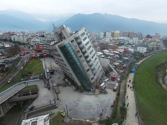 A residential building leans on a collapsed first floor following an earthquake, Wednesday, Feb. 7, 2018, in Hualien, southern Taiwan. Rescue crews continue to try free people from damaged buildings a ...