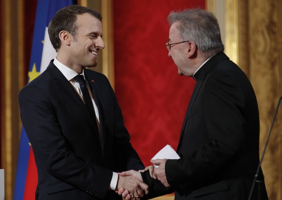 FILE - In this Jan.4, 2018 file photo, French President Emmanuel Macron, left, greets Apostolic Nuncio to France Luigi Ventura, at the Elysee Palace in Paris. Multiple men have accused Archbishop Luig ...