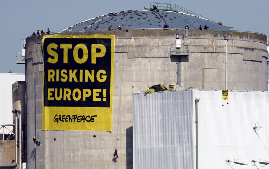 epa04130684 A protest banner from Greenpeace with text reading &#039;Stop Risking Europe!&#039; is seen at the Fessenheim nuclear power plant in Fessenheim, France, 18 March 2014. An estimated 50 acti ...