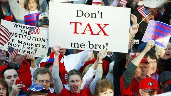 A woman holds a sign that reads &quot;Don&#039;t tax me bro! &quot; during the Atlanta Tea Party tax protest Wednesday, April 15, 2009 in Atlanta. Thousands of protesters, some dressed like Revolution ...