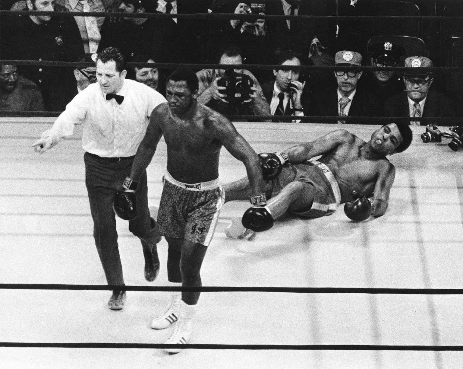In this March 8, 1971 photo, boxer Joe Frazier is directed to the ropes by referee Arthur Marcante after knocking down Muhammad Ali during the 15th round of the title bout in Madison Square Garden in  ...