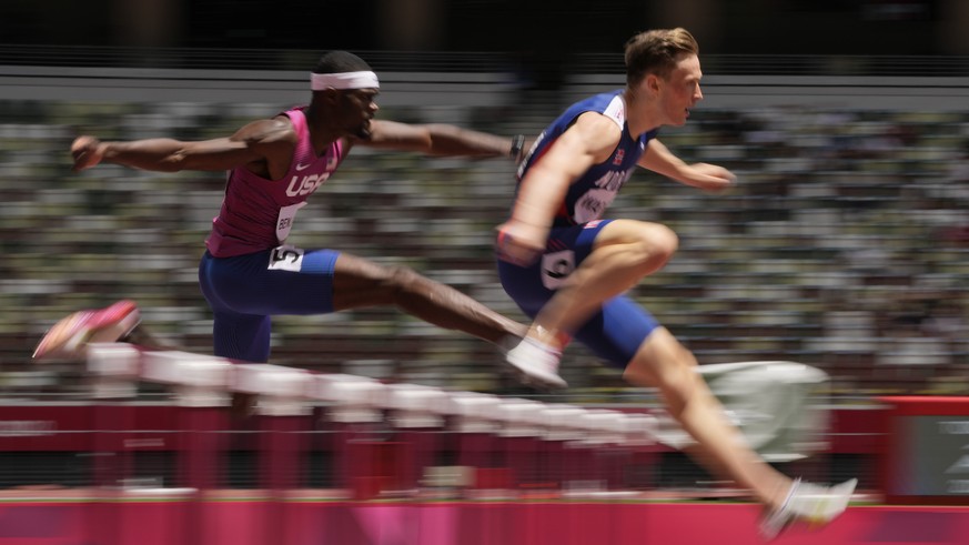 Karsten Warholm, right, of Norway, leads Rai Benjamin, of United States, in the final of the men&#039;s 400-meter hurdles at the 2020 Summer Olympics, Tuesday, Aug. 3, 2021, in Tokyo. (AP Photo/Franci ...