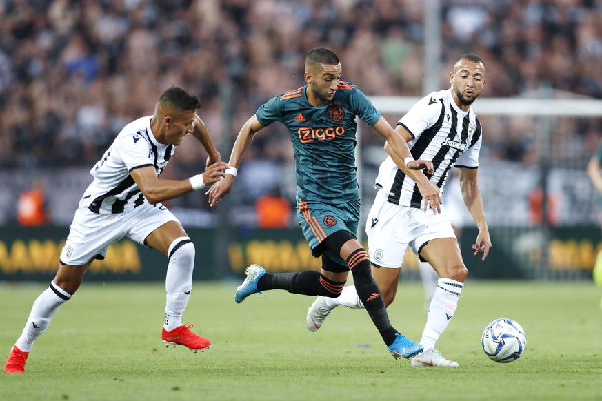 epa07759670 (L-R) Dimitris Giannoulis of PAOK FC, Hakim Ziyech of Ajax and Omar El Kaddouri of PAOK FC in action during the UEFA Champions League third qualifying round first leg soccer match between  ...