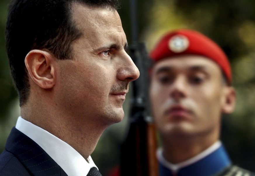 FILE - In this Monday, Dec. 15, 2003 file photo, Syrian President Bashar Assad reviews the presidential guard during a welcoming ceremony in Athens. The tide of global rage against the Islamic State g ...