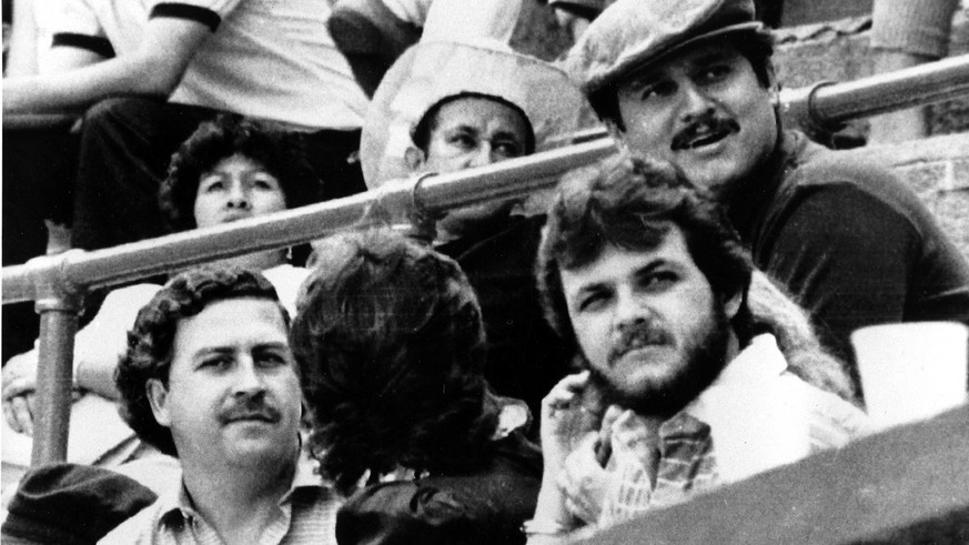 Pablo Escobar, left, and Jorga Luis Ochoa, right with hat, the two leaders of the Medellin cocaine cartel, are shown at a bullfight in Medellin, Colombia, in 1984. (AP Photo)