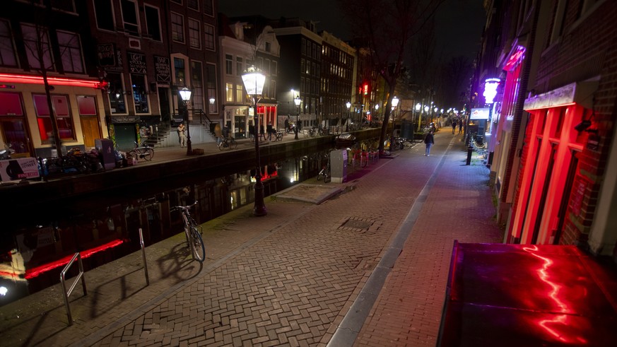 View of the near-empty Red Light District in Amsterdam, Netherlands, Sunday, March 15, 2020, after a TV address of health minister Bruno Bruins who ordered all Dutch schools, cafes, restaurants, inclu ...