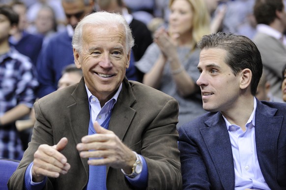 FILE - In this Jan. 30, 2010, file photo, Vice President Joe Biden, left, with his son Hunter, right, at the Duke Georgetown NCAA college basketball game in Washington. Hunter Biden is expressing regr ...