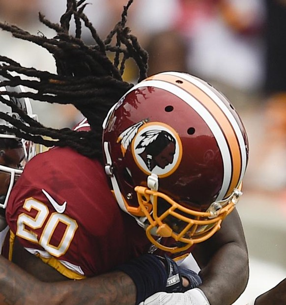 Washington Redskins running back Rob Kelley (20) attempts to run the ball while being tackled by Los Angeles Rams linebacker Mark Barron (26) during the first half of an NFL football game Sunday, Sept ...