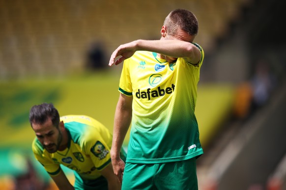 epa08540142 A dejected Marco Stiepermann of Norwich after West Ham scored the opening goal during the English Premier League match between Norwich City and West Ham United in Norwich, Britain, 11 July ...