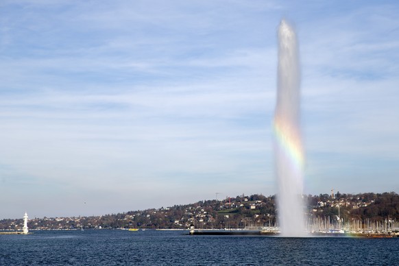 epa08833603 A rainbow is formed by the famous water fountain (Jet d&#039;eau) in front of a lighthouse of the Geneva&#039;s harbour, in Geneva, Switzerland, 21 November 2020. In Geneva, the Jet d&#039 ...