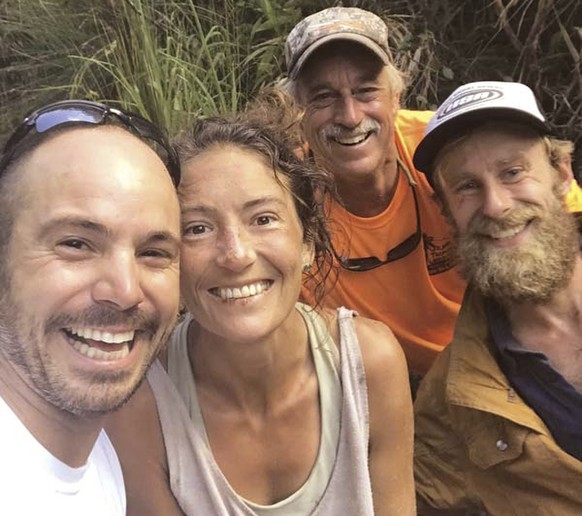 In this Friday, May 24, 2019, photo provided by Troy Jeffrey Helmer, resident Amanda Eller, second from left, poses for a photo after being found by searchers, Javier Cantellops, far left, Helmer and  ...