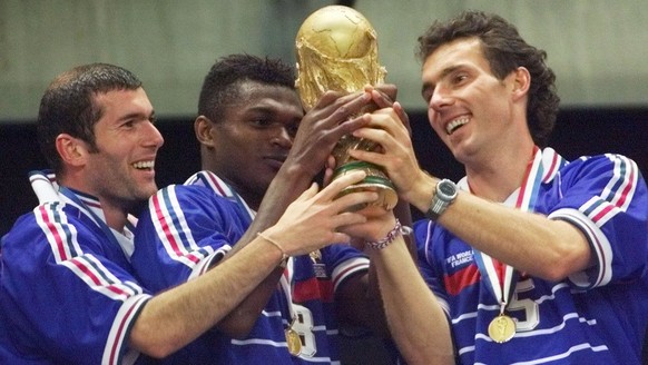 French teammates from left : Zinedine Zidane, Marcel Desailly and Laurent Blanc hold the World Cup after France defeated Brazil 3-0 in the final of the World Cup 98at the Stade de France in Saint Deni ...