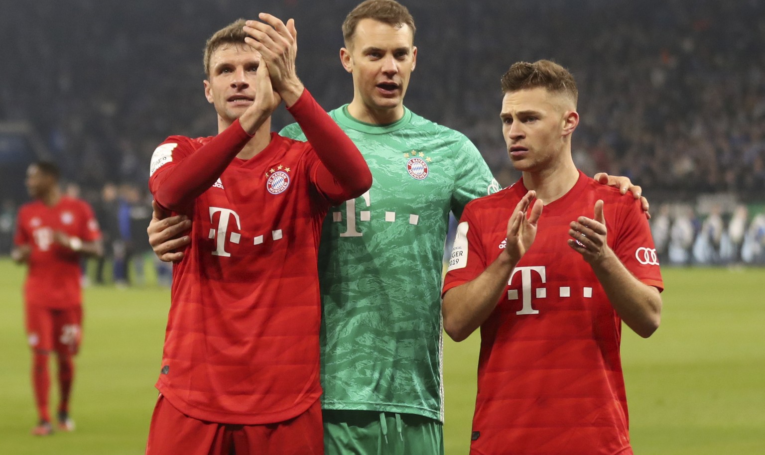epa08267985 (L-R) Thomas Mueller, Manuel Neuer and Joshua Kimmich of Bayern Munich celebrate after winning the German DFB Cup quarter final match between Schalke 04 and Bayern Munich in Gelsenkirchen, ...
