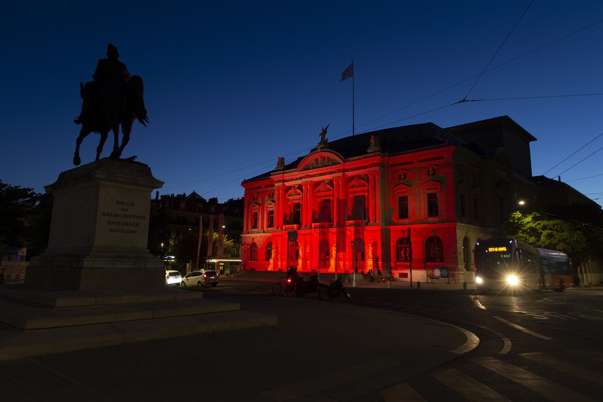 epa08502839 The Grand Theatre de Geneve (Opera house of Geneva) is illuminated in red to mark the dramatic situation in the event industry due to the coronavirus COVID-19 pandemia, during the &#039;Ni ...