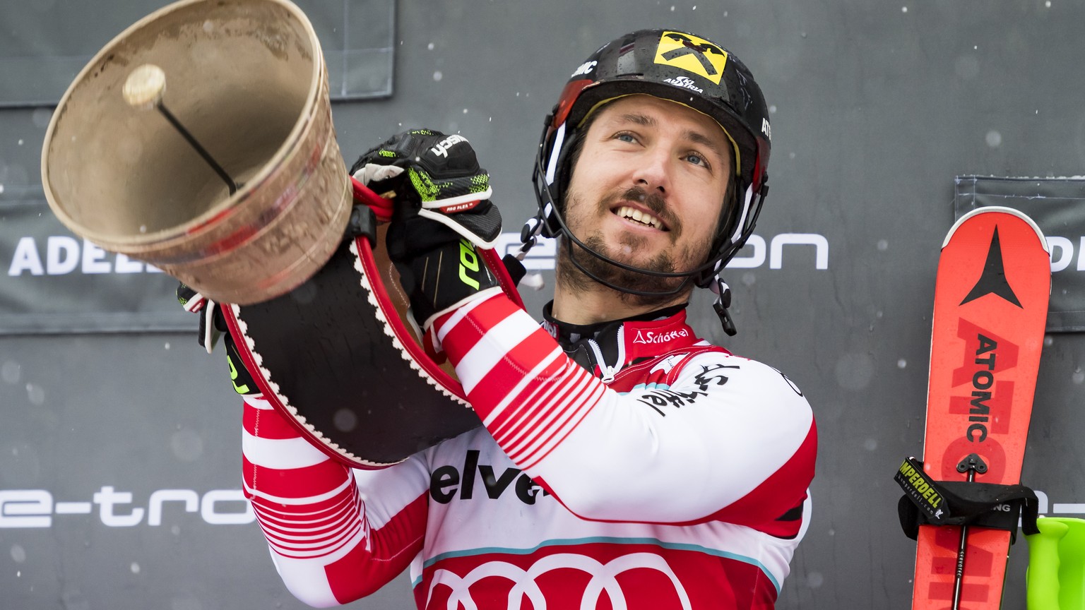 Winner Marcel Hirscher of Austria, celebrates with a Swiss Cow Bell on the podium after the second run of the men&#039;s slalom race at the Alpine Skiing FIS Ski World Cup in Adelboden, Switzerland, S ...