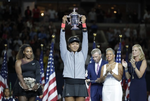 FILE - In this Sept. 8, 2018, file photo, Naomi Osaka, of Japan, holds the trophy after defeating Serena Williams in the women&#039;s final of the U.S. Open tennis tournament, in New York. Caroline Wo ...