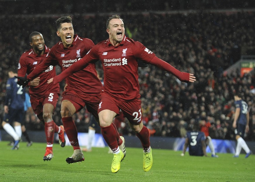 Liverpool&#039;s Xherdan Shaqiri, right, celebrates after scoring his side&#039;s third goal during the English Premier League soccer match between Liverpool and Manchester United at Anfield in Liverp ...