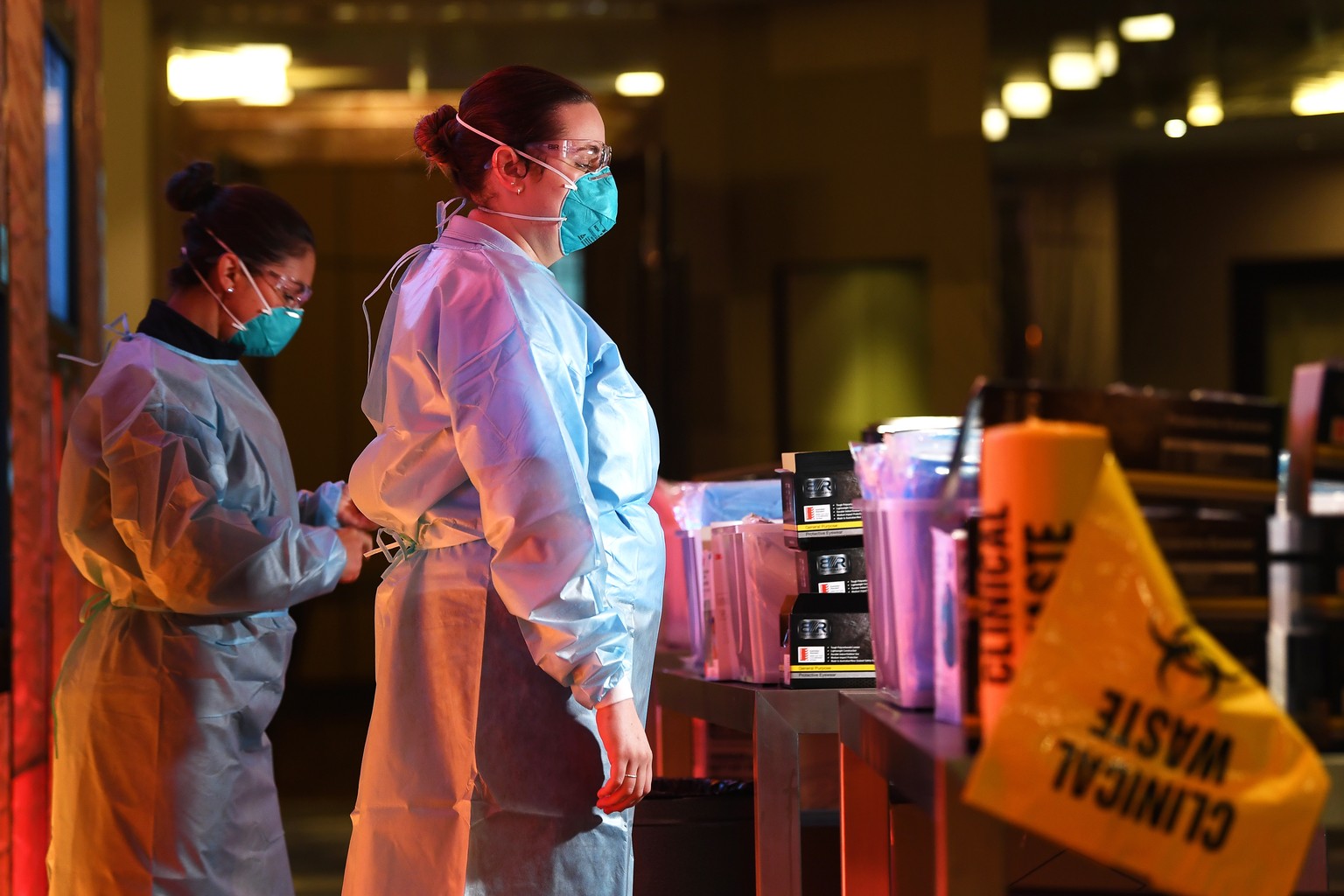 epa08984434 (FILE) - Healthcare workers stand at a personal protective equipment station inside the Grand Hyatt Melbourne in Melbourne, Australia, 12 January 2021 (re-issued on 03 February 2021). Hund ...