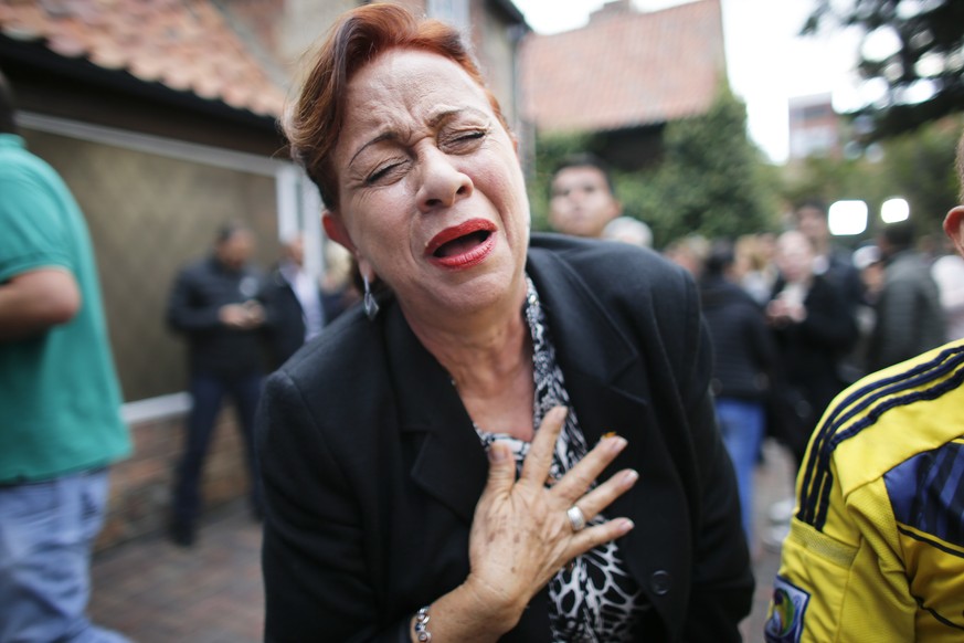 An opponent to the peace deal signed between the Colombian government and rebels of the Revolutionary Armed Forces of Colombia, FARC, celebrates after she listened to the results of the referendum to  ...