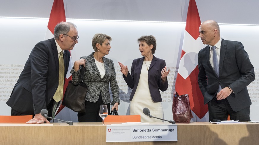 Swiss Federal president Simonetta Sommaruga, second right, and from left, Federal councillors Guy Parmelin, Karin Keller-Sutter and Alain Berset talk after the media briefing about the latest measures ...