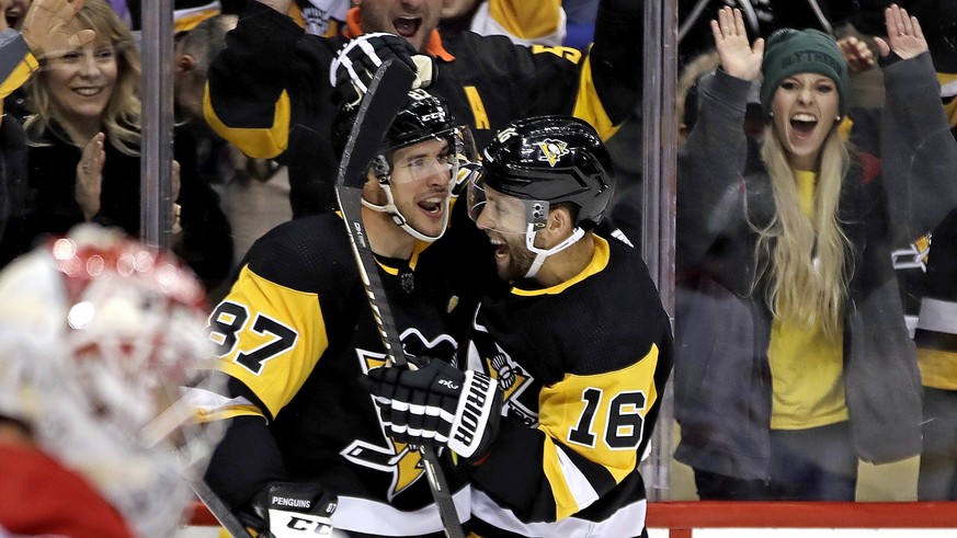 Pittsburgh Penguins&#039; Jason Zucker (16) celebrates his goal with Sidney Crosby (87) during the second period of the team&#039;s NHL hockey game against the Montreal Penguins in Pittsburgh, Friday, ...
