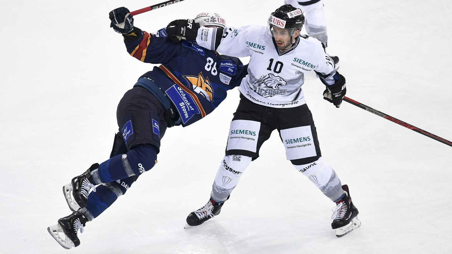Ice Tigers`sTaylor Aronson, right, gets Magnitogorsk`s Michal Bulir out of the way, during the game between HK Metallurg Magnitogorsk and Thomas Sabo Ice Tigers at the 92th Spengler Cup ice hockey tou ...