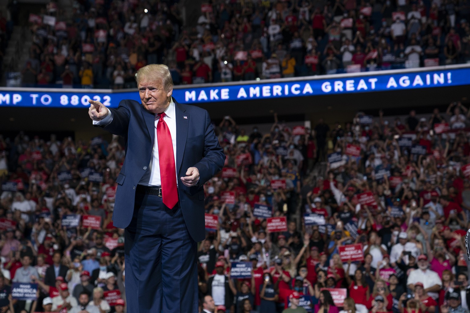 In this June 20, 2020, photo, President Donald Trump arrives on stage to speak at a campaign rally at the BOK Center in Tulsa, Okla. President Donald Trump is sharpening his focus on his ardent base o ...