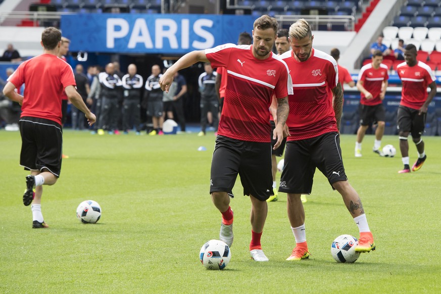Swiss forward Haris Seferovic,center, and Swiss midfielder Valon Behrami, right, in action during a team&#039;s training session, at the Parc des Princes stadium, in Paris, France, Tuesday, June 14, 2 ...