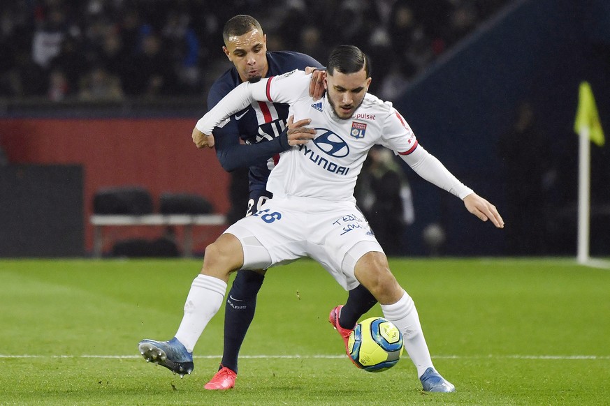 epa08206442 Lyon&#039;s Ryan Cherki (R) and Paris Saint Germain&#039;s Layvin Kurzawa (L) in action during the French Ligue 1 soccer match between PSG and Lyon at the Parc des Princes stadium in Paris ...