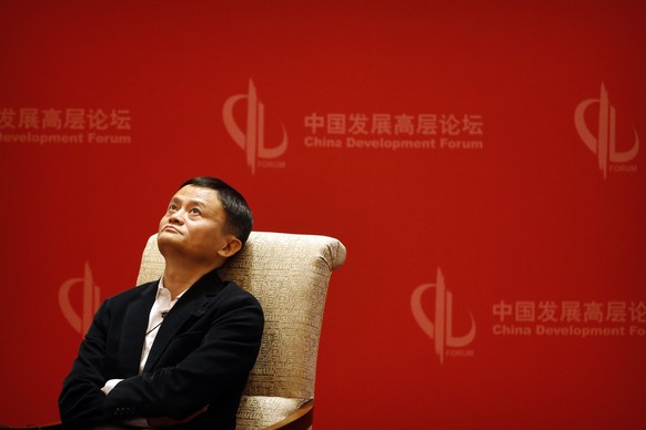 In this file photo taken Saturday, March 19, 2016, Jack Ma, executive chairman of the Alibaba Group, looks up during a panel discussion held as part of the China Development Forum at the Diaoyutai Sta ...