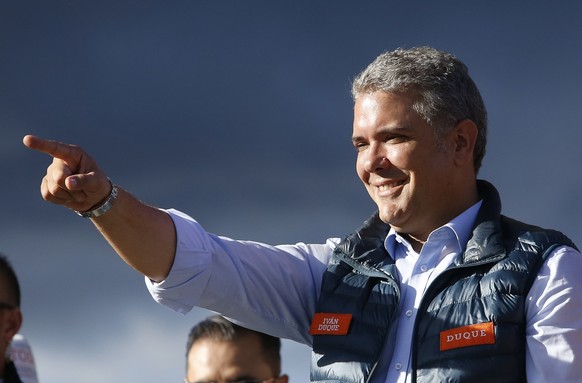 FILE - In this May 20, 2018 file photo, presidential candidate Ivan Duque acknowledges supporters during a campaign rally in Bogota, Colombia. Duque is considered the candidate to beat, but in an unex ...