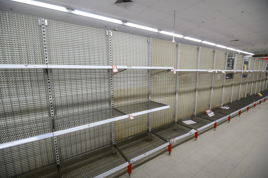 epa08291093 Shelves are empty of toilet rolls at Coles Supermarket, Parramatta in Sydney, Australia, 13 March 2020. Panic buying related to the coronavirus and COVID-19 pandemic has led to shortages o ...