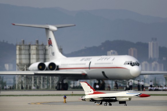 In this Sept. 25, 2016, file photo, a remote-controlled F-16 fighter jet lands in front of an Air Koryo commercial airplane at the Kalma Airport after a flight demonstration in Wonsan, North Korea. Th ...